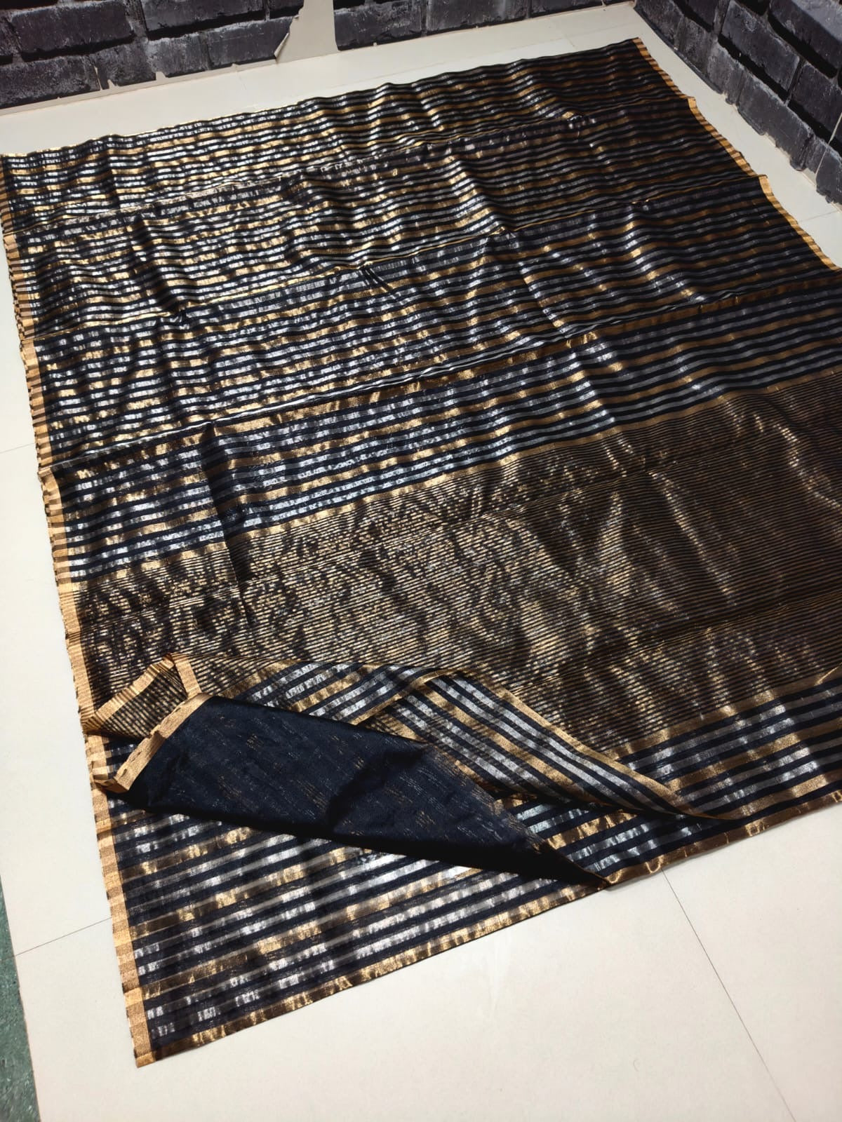 Black body close-up showing silver-gold pinstripe detail