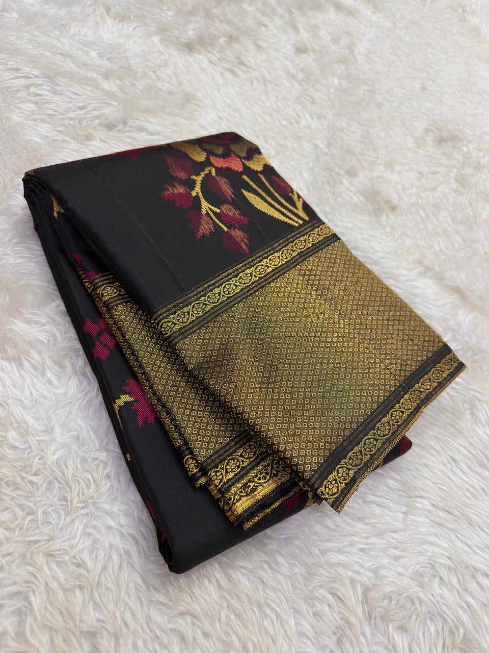 Black pure silk Kanjivaram saree with large floral jaal and layered botanical coloration.