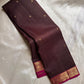 Draped deep brown checked pure Kanchipuram silk saree with small gold buttas and magenta zari border