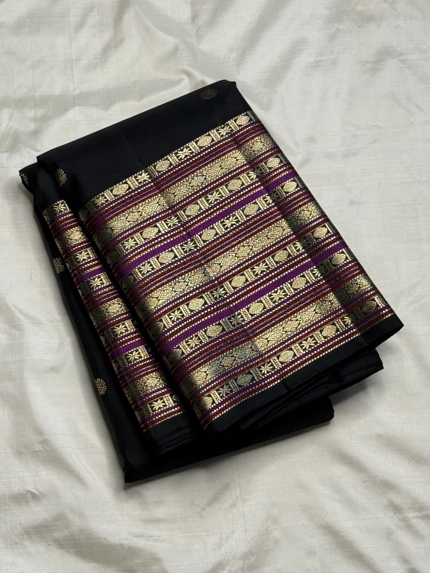 Full black Kanchipuram saree with Varisaipet border, folded view