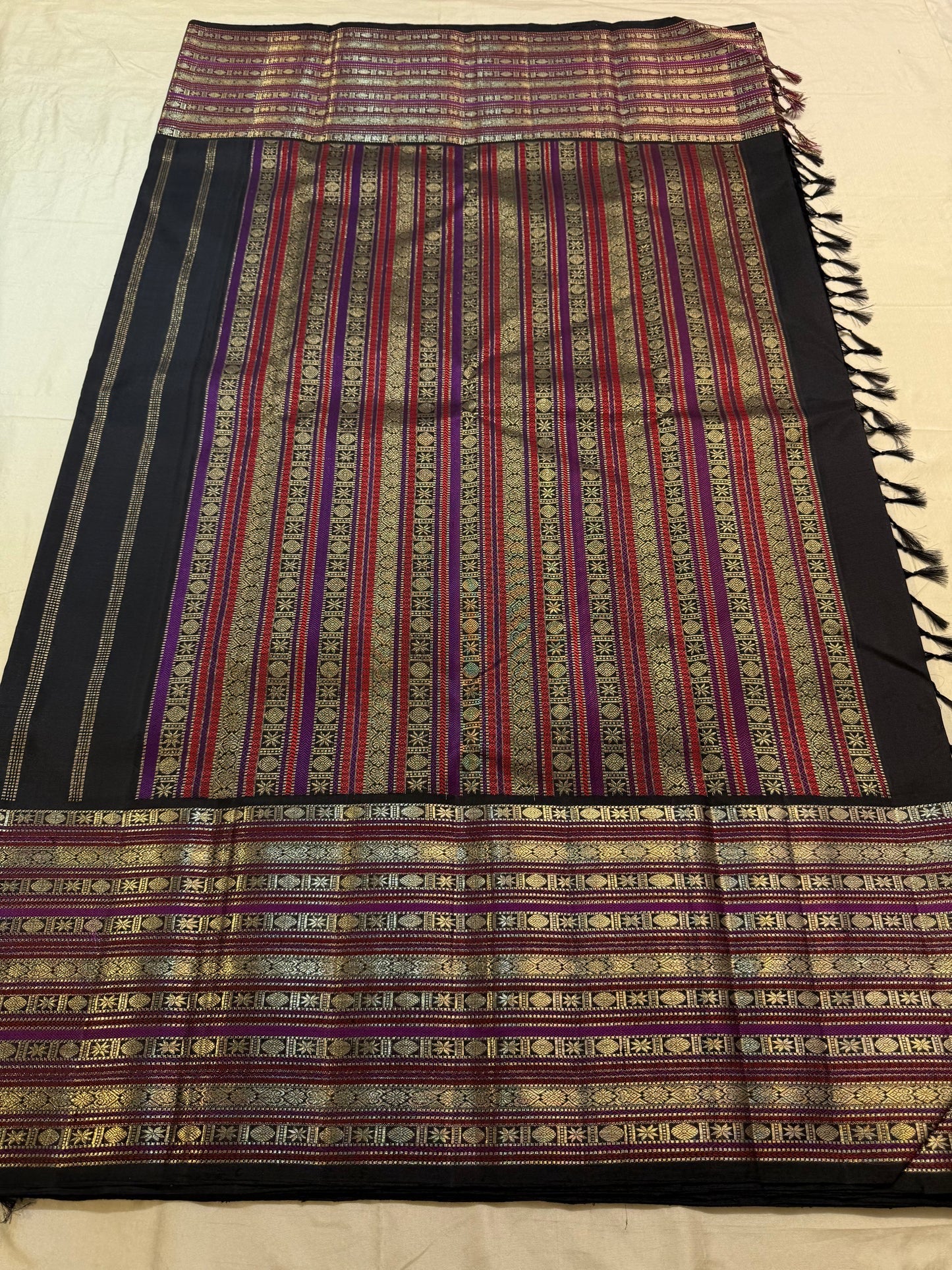 Matching silk-thread-and-zari pallu detail on black saree