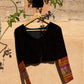 Close-up of Banarasi kimkhwab silk sleeve with zari woven floral motifs on black velvet blouse