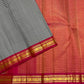 Black and white Kanchi Kattam saree with warm orange-red and pink contrast pallu