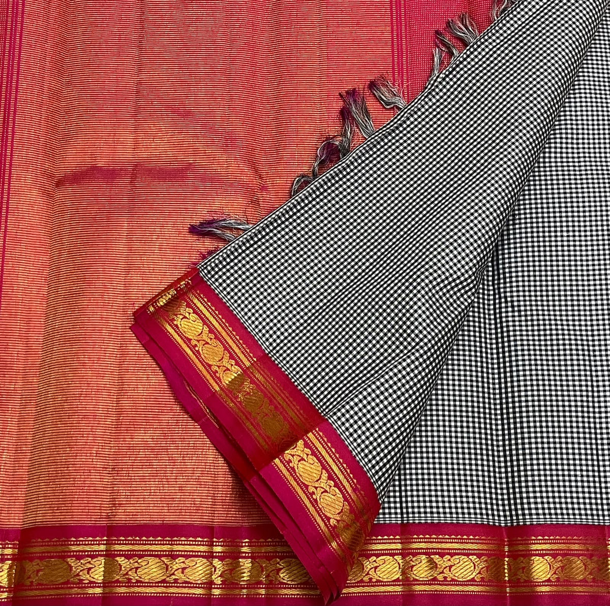 Fine black and white checked Kanchi Kattam silk body beside deep pink and gold zari border