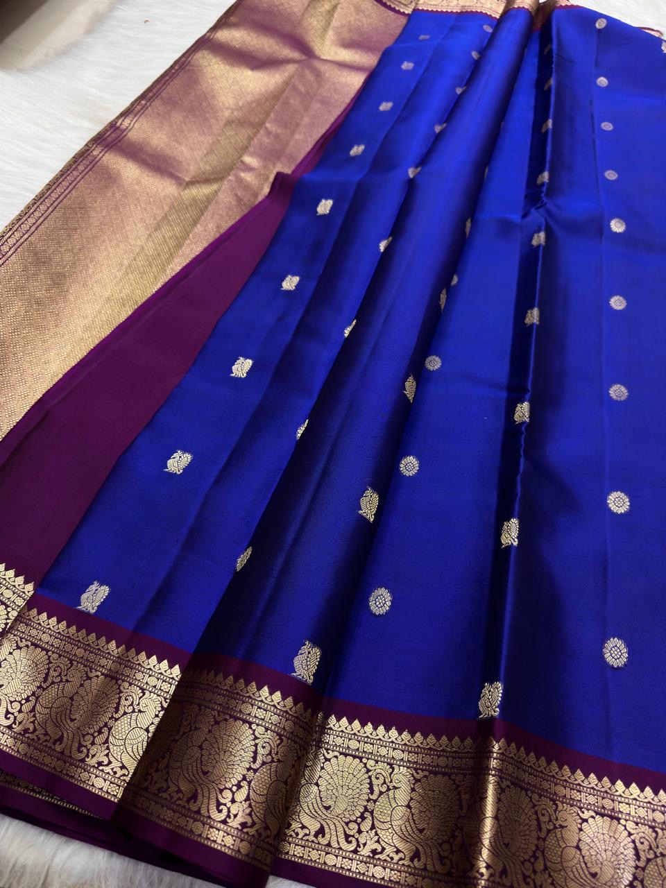 Royal Blue Kanjivaram body with traditional spaced antique-gold zari motifs.