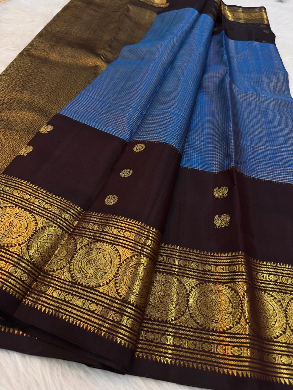 Close view of antique-gold zari butta on Azure Blue Kanjivaram silk.