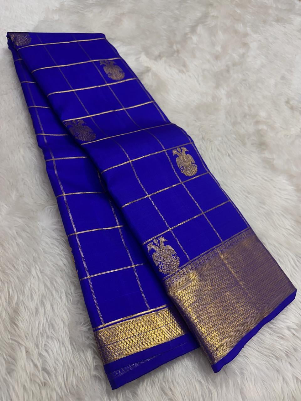 Royal Blue Pure Silk Kanchipuram saree with antique gold Zari Kattam checks, handwoven Gandaberunda motifs and broad zari border.