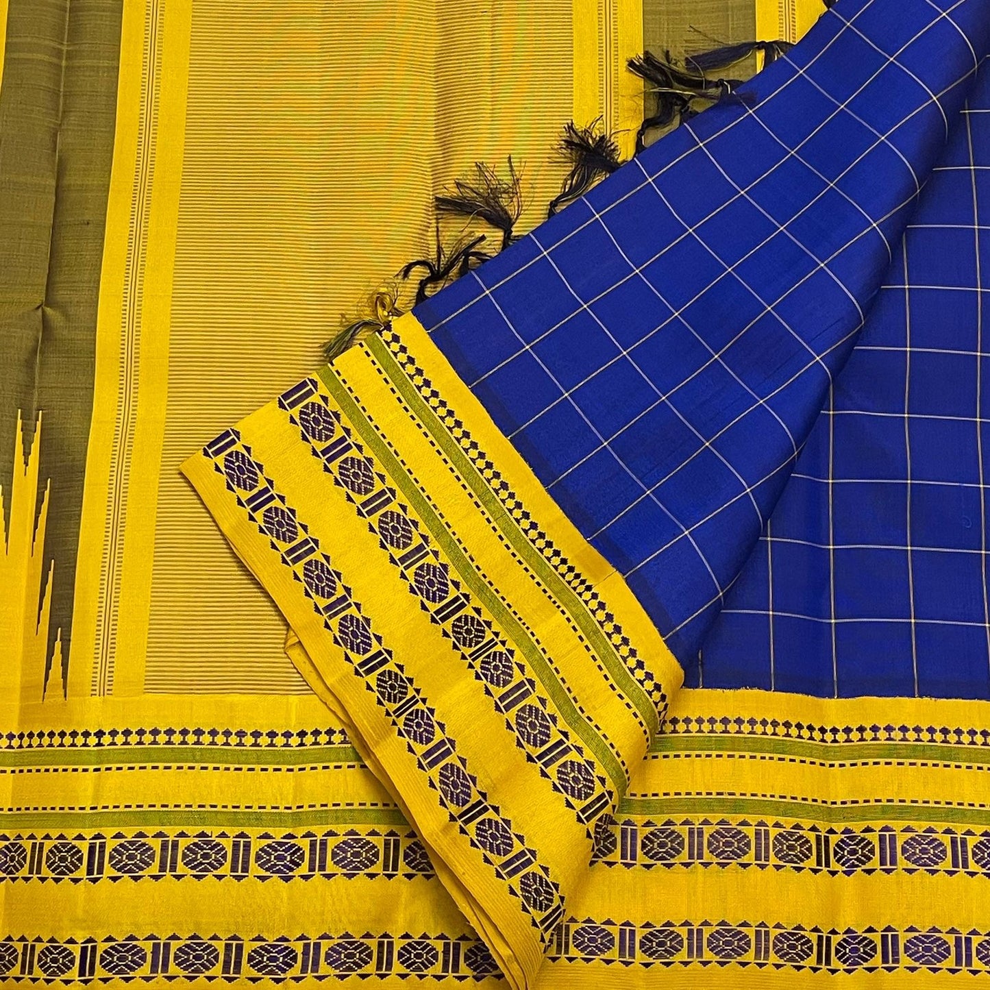 Draped detail of royal blue checked pure Kanchipuram silk saree with mustard yellow border and patterned edge, available in the USA