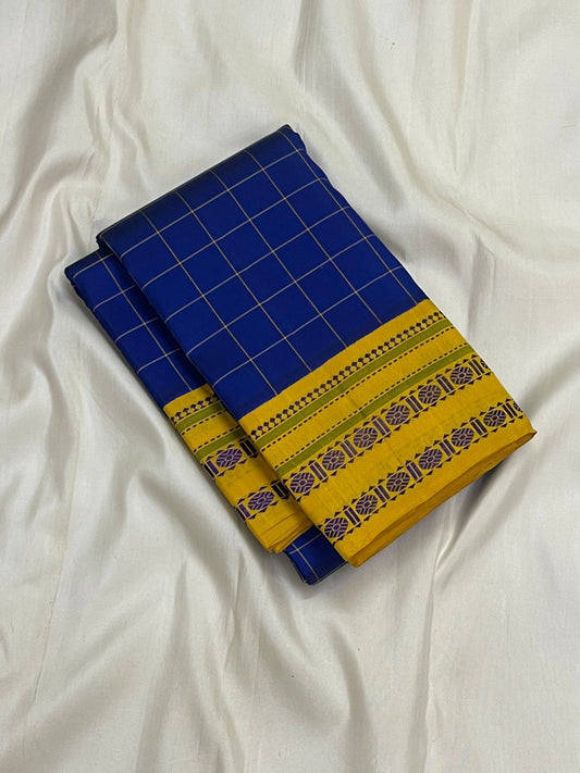 Folded royal blue pure Kanchipuram silk saree with fine checked pattern and mustard yellow border on white backdrop
