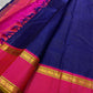 Pure Kanchipuram silk saree folded closeup highlighting blue check pattern and wide pink zari border with gold detailing