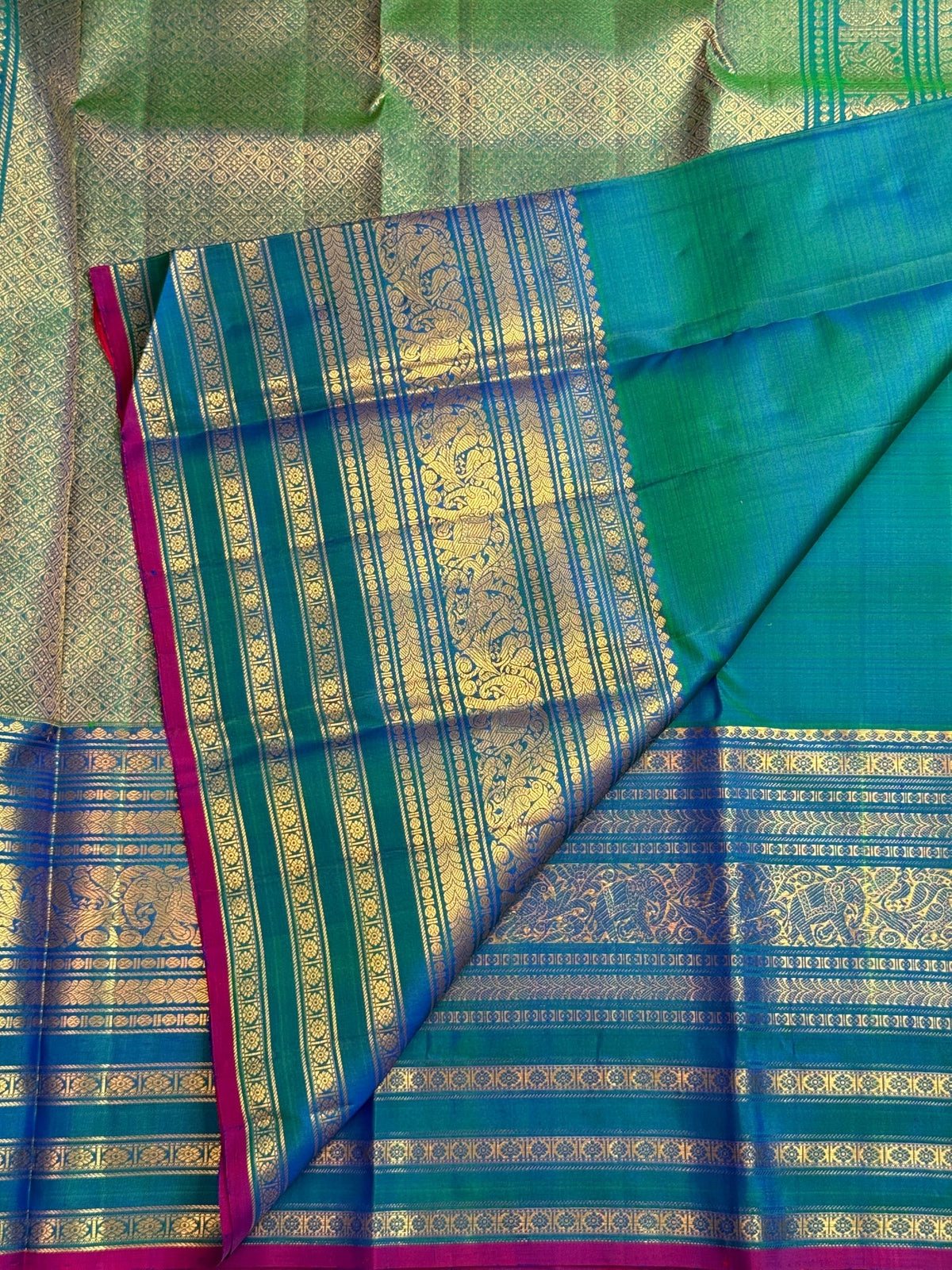 Iridescent peacock-neck blue and green pure silk Kanchipuram saree, petite peacock zari buttas blue green; traditional Varisaipet weave.