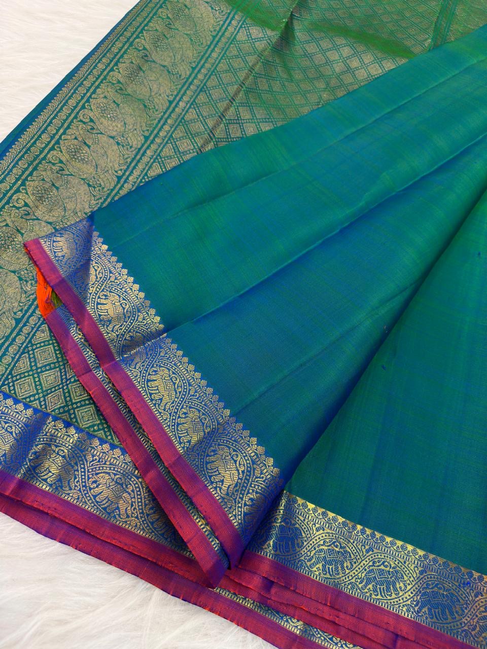 Peacock Blue Handwoven Pure Silk KanchiPattu Saree with Small Gold Buttas & Petite Zari Elephant Border