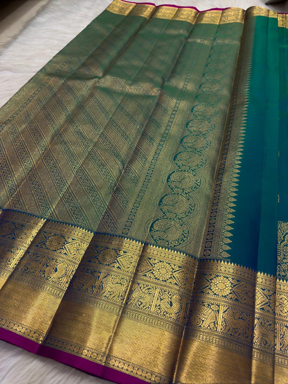 Blue-green Pure Silk Kanchipuram saree with Rani-pink edge, Koodu Mayil motifs and ornate Chakram panels