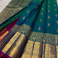 Traditional blue-green Kanchipuram silk with temple-koodu Mayil motifs, Chakram rosettes and Vanki detailing