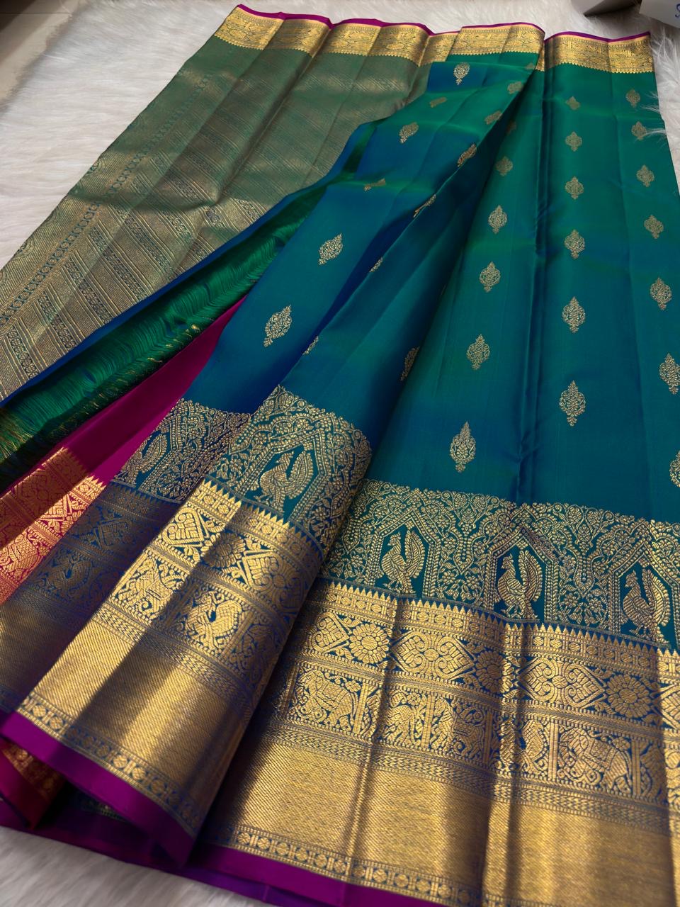 Traditional blue-green Kanchipuram silk with temple-koodu Mayil motifs, Chakram rosettes and Vanki detailing