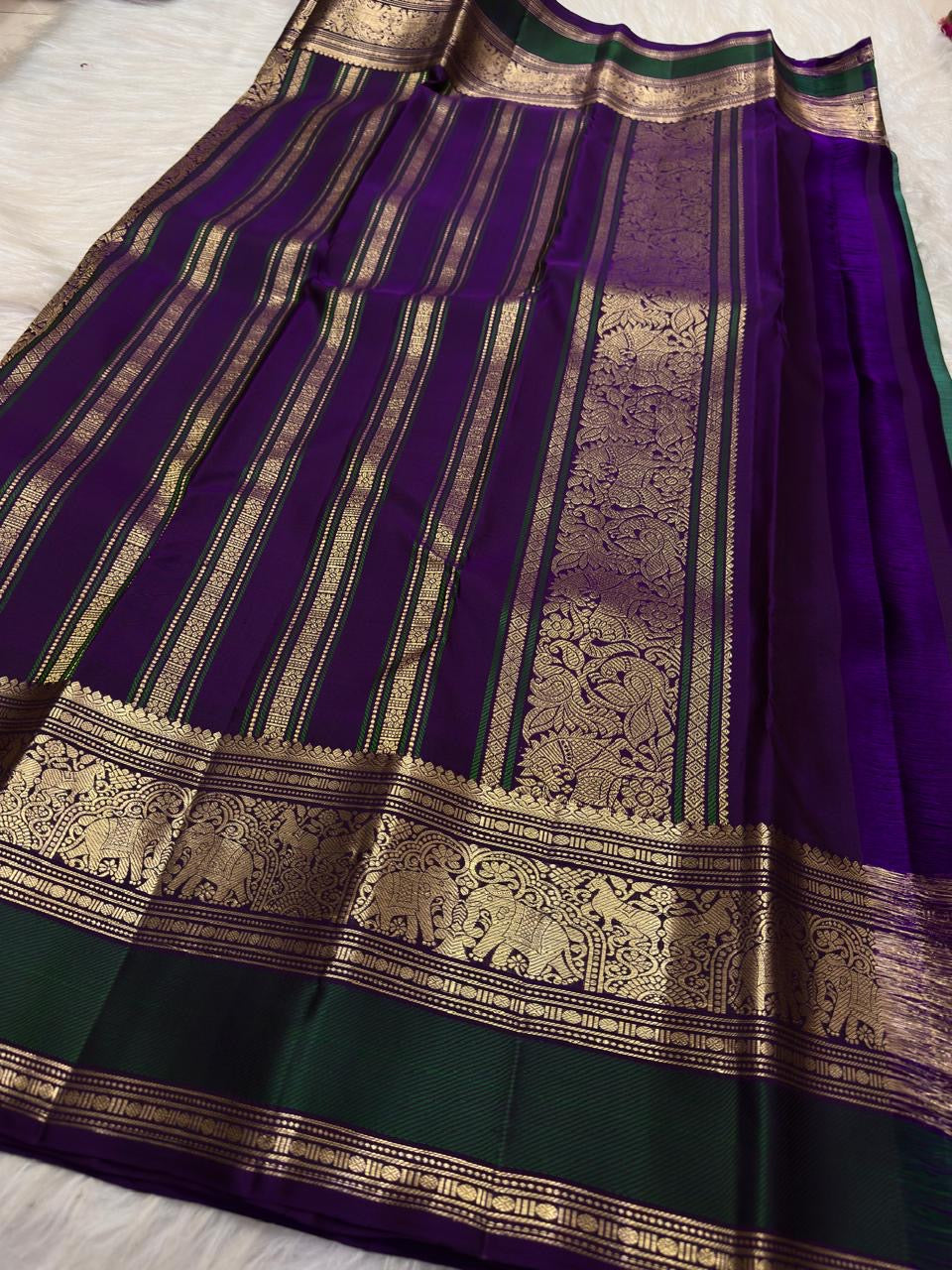 Mayil Kazhuthu Green Kanjivaram saree with ornate Royal Purple Yanai motif border