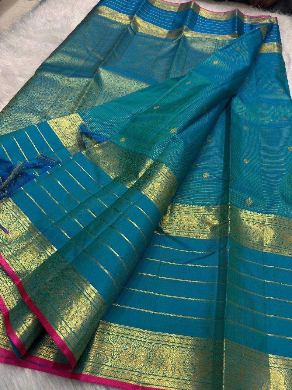 Blue-green pure mulberry silk Varisaipet saree with fine gold lines and Rani Pink selvedge.