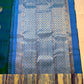 Sky Blue Kanchipuram pallu with dense gold zari lattice, floral ornamental registers and Peacock Blue-Green silk body.
