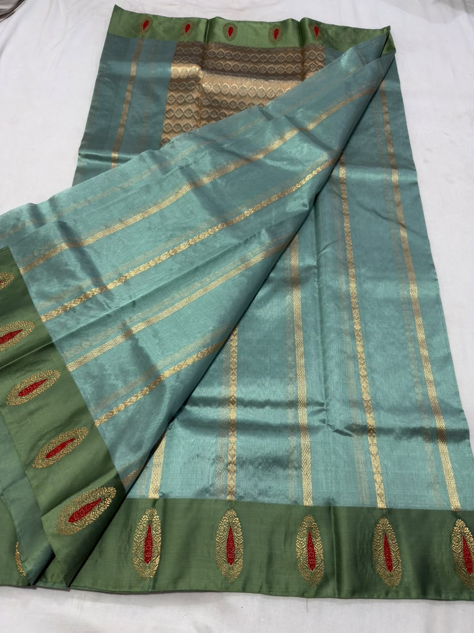 Handloom sea glass blue Pattu Silk Chanderi saree draped to show body and border