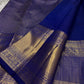 Royal blue saree showing small gold buttas and gold zari border, draped on light fabric, available in the USA