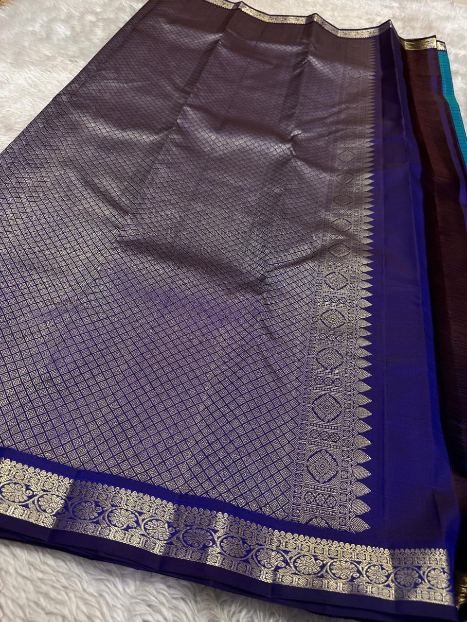 Indigo pallu section with silver zari woven border and smooth silk finish