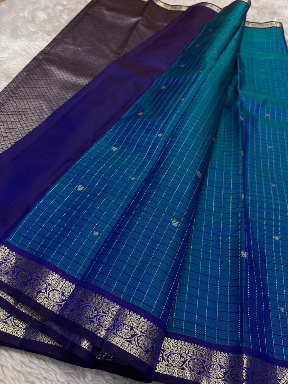 Pure Kanchipuram Silk Saree laid out in blue muthu kattam checks with indigo zari woven border, available in the USA