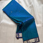Blue muthu kattam Pure Kanchipuram Silk Saree shown draped with indigo zari woven border and silver motifs on the body