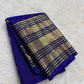 Royal blue Kanchipuram saree with an ornate peacock-arch zari border.