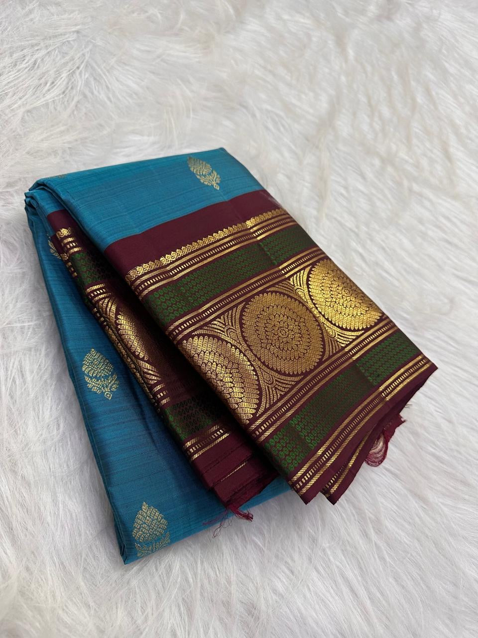 Handwoven blue Kanjivaram saree with Deep Maroon and Peacock Green contrast border
