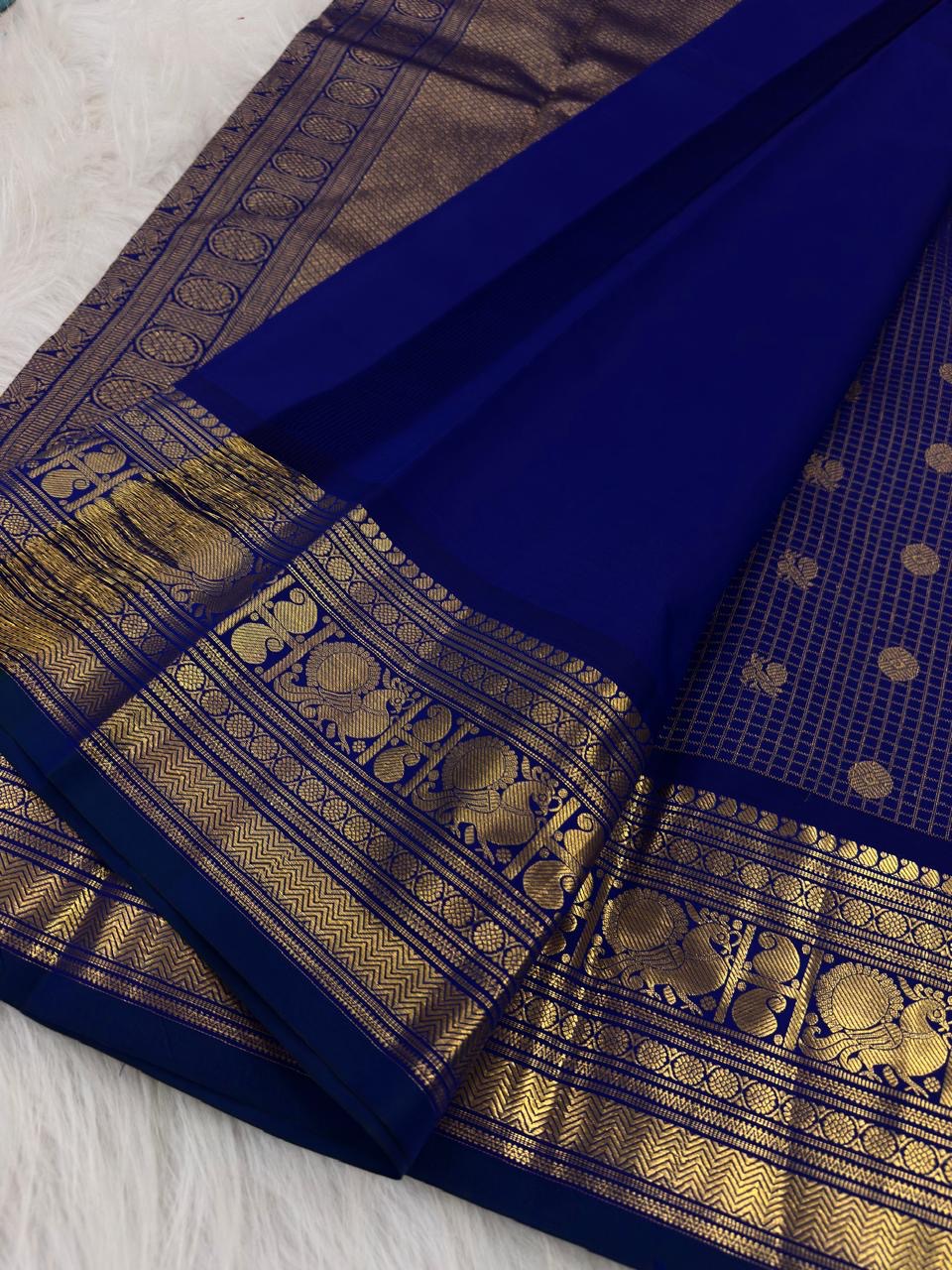 Royal blue Kanjipuram saree, gold zari checks and zari buttas detail