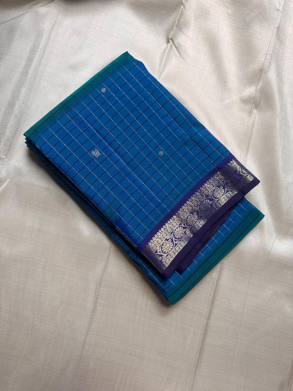 Folded Pure Kanchipuram Silk Saree in blue muthu kattam checks with small silver motifs and indigo zari woven border