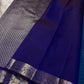 Indigo pallu section with silver zari woven border and smooth silk finish
