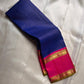 Pure Kanchipuram silk saree draped showing blue checked body, contrasting pink zari border, and blue tassels along the edge