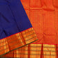 Royal-blue silk meeting a burnt-orange Varisaipet border with broad classic-gold zari registers.