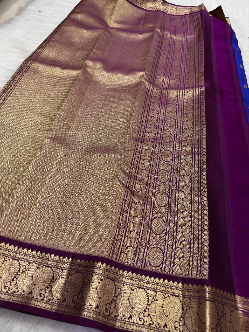 Close view of Royal Blue Kanchipuram silk with traditional gold zari buttas.