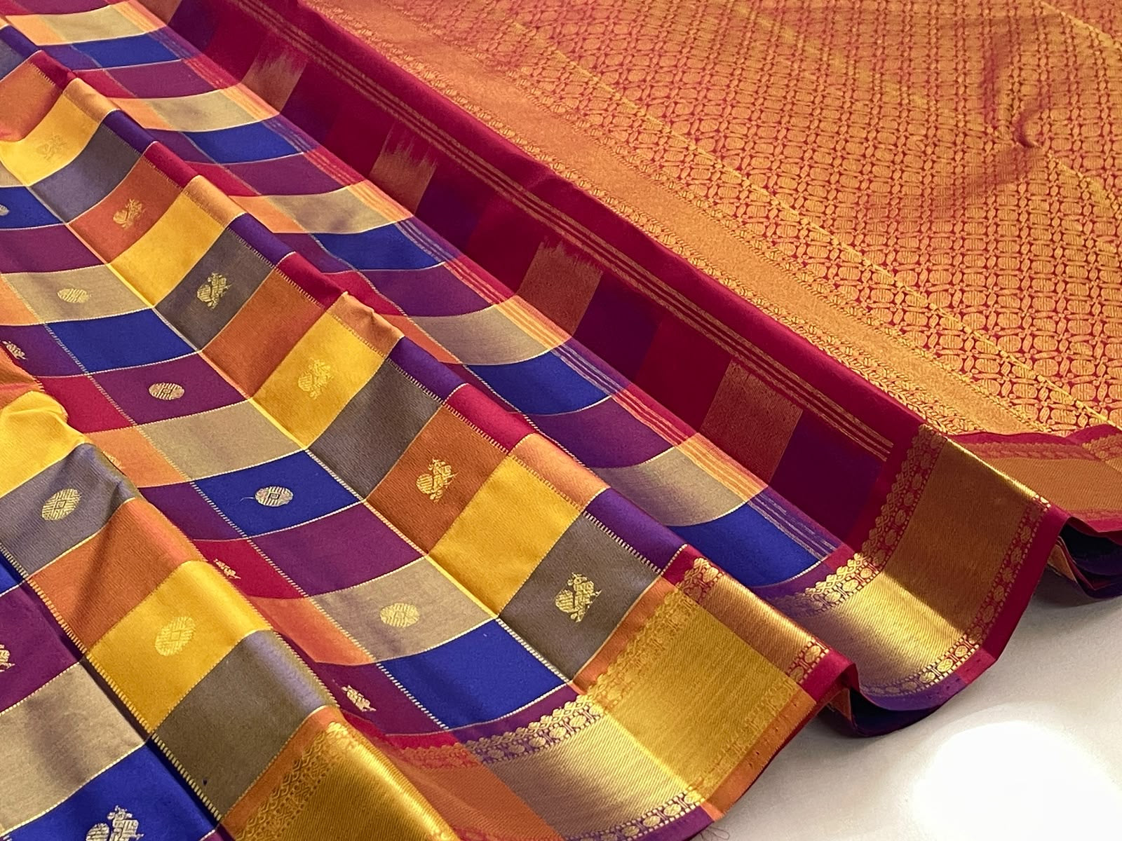 Close view of Paalum Pazhamum checks with individually woven antique-gold zari motifs.