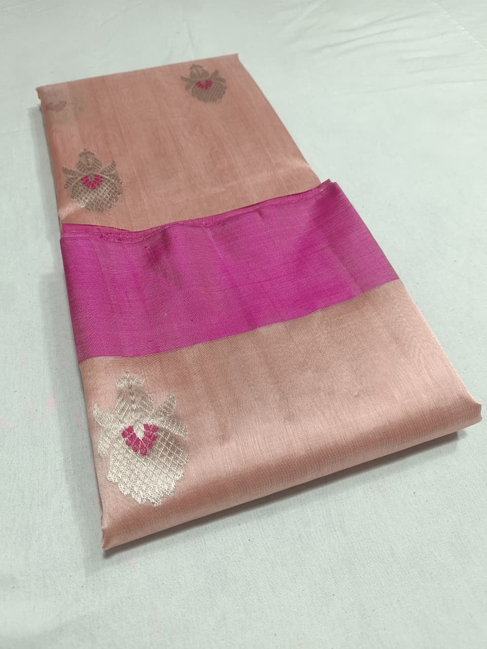 Blush Peach Pattu Silk Chanderi saree displayed in full to show the overall drape and silver floral motifs