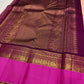Vivid pink and deep aubergine Rettapet border detail on blush peach Kanjivaram saree