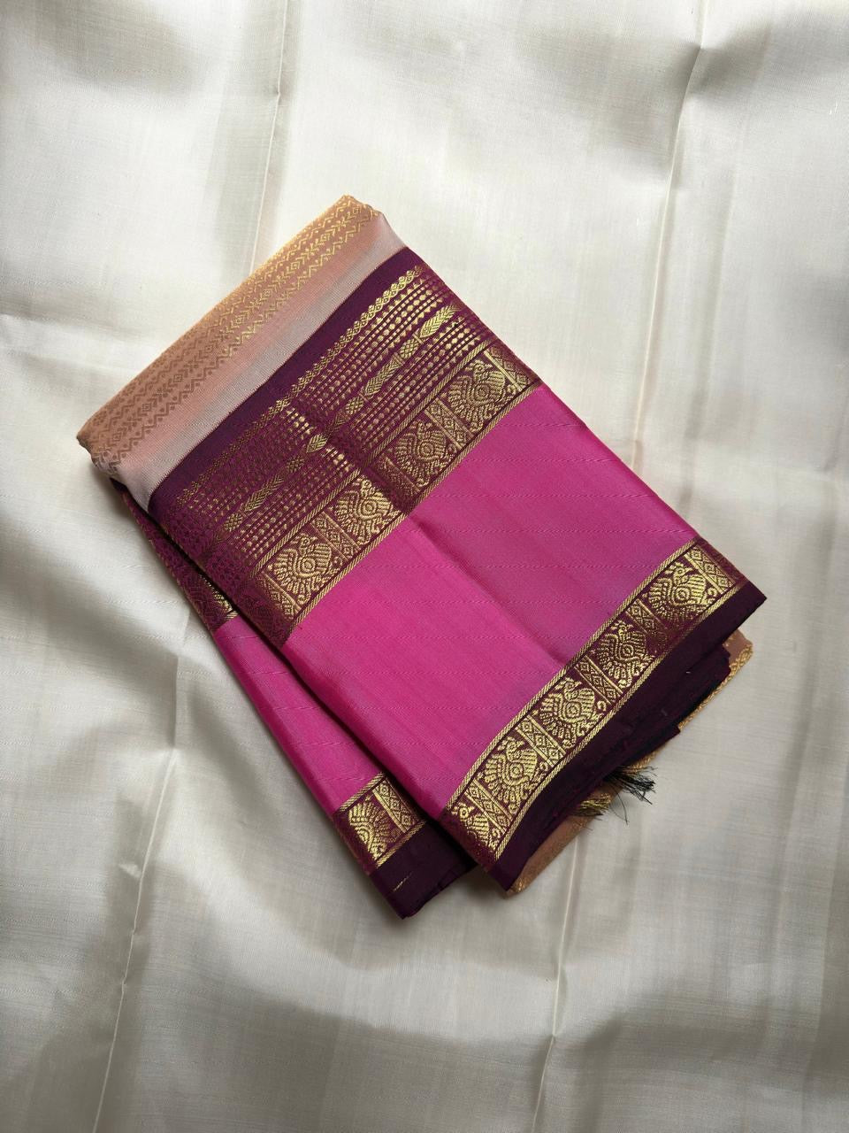 Pallu detail of blush peach Kanjivaram Rettapet saree with pink and aubergine zari