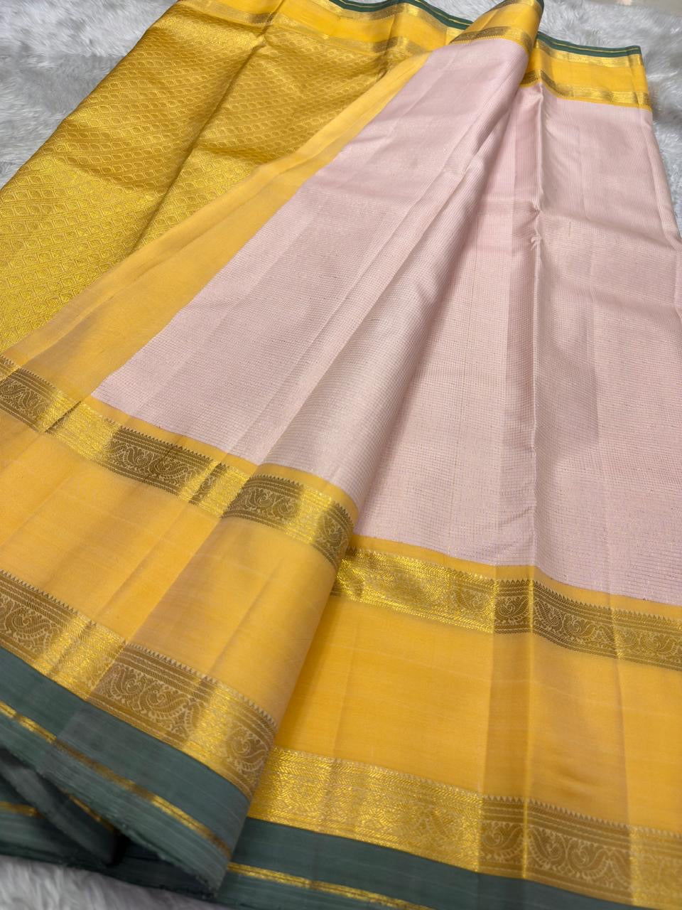 Kanchipattu silk saree in blush pink with butter yellow sage grey border border Korvai Rettapet weave traditional zari detail