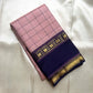 Folded blush pink checked pure Kanchipuram silk saree with deep navy zari woven border featuring star motifs, available in the USA