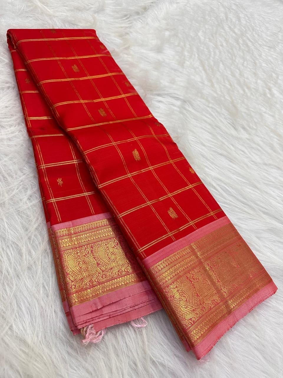 Broad luminous gold zari border finished with a narrow soft Blush-Pink edge.