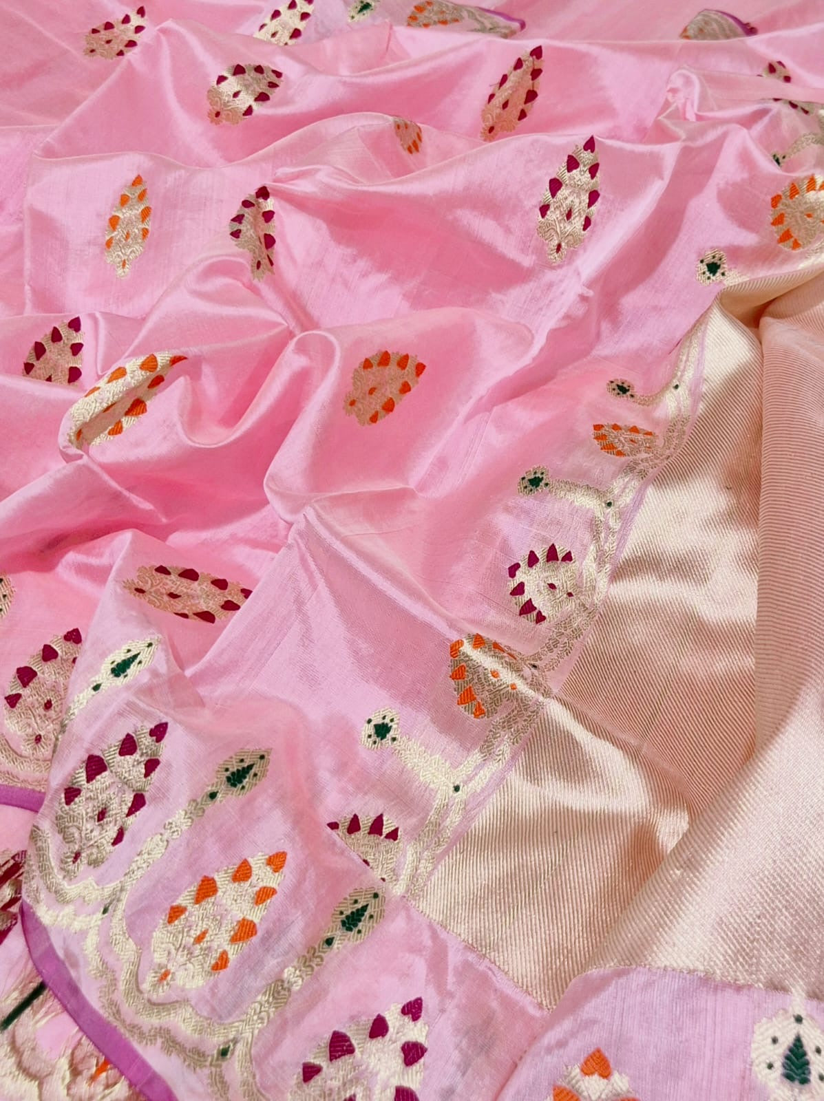 Blush pink Chanderi silk saree showing multicolour ornamental woven border and softly reflective striped pallu