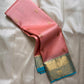 Blush pink pure Kanchipuram silk saree with gold paisley buttas and sky blue zari woven border, draped on light fabric