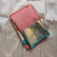 Folded blush pink pure Kanchipuram silk saree with sky blue border and gold zari woven pallu, flat lay, shipped from New Jersey USA