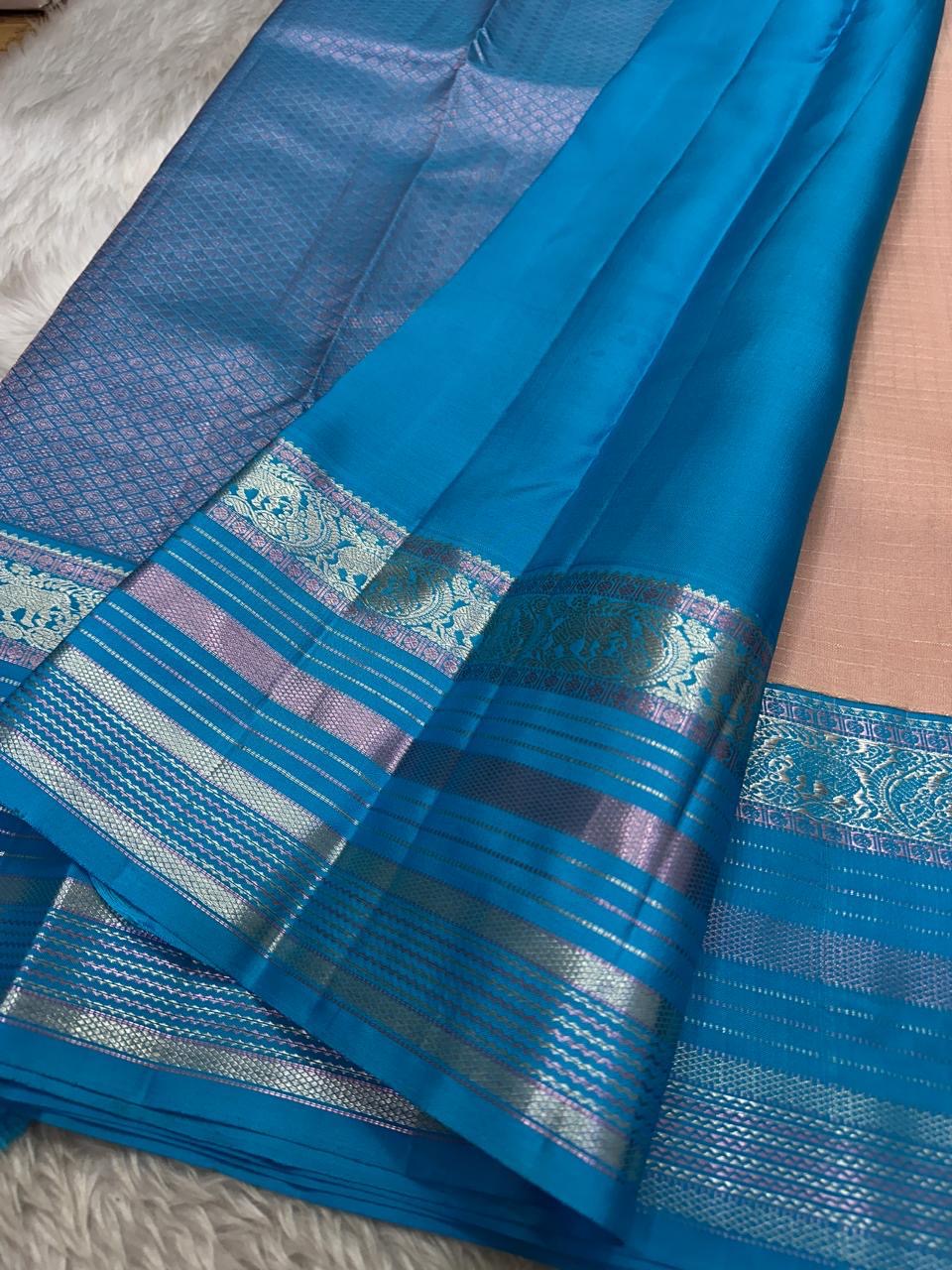 Kanchipattu silk saree in blush pink with turquoise blue border Zari Kattam weave traditional zari detail