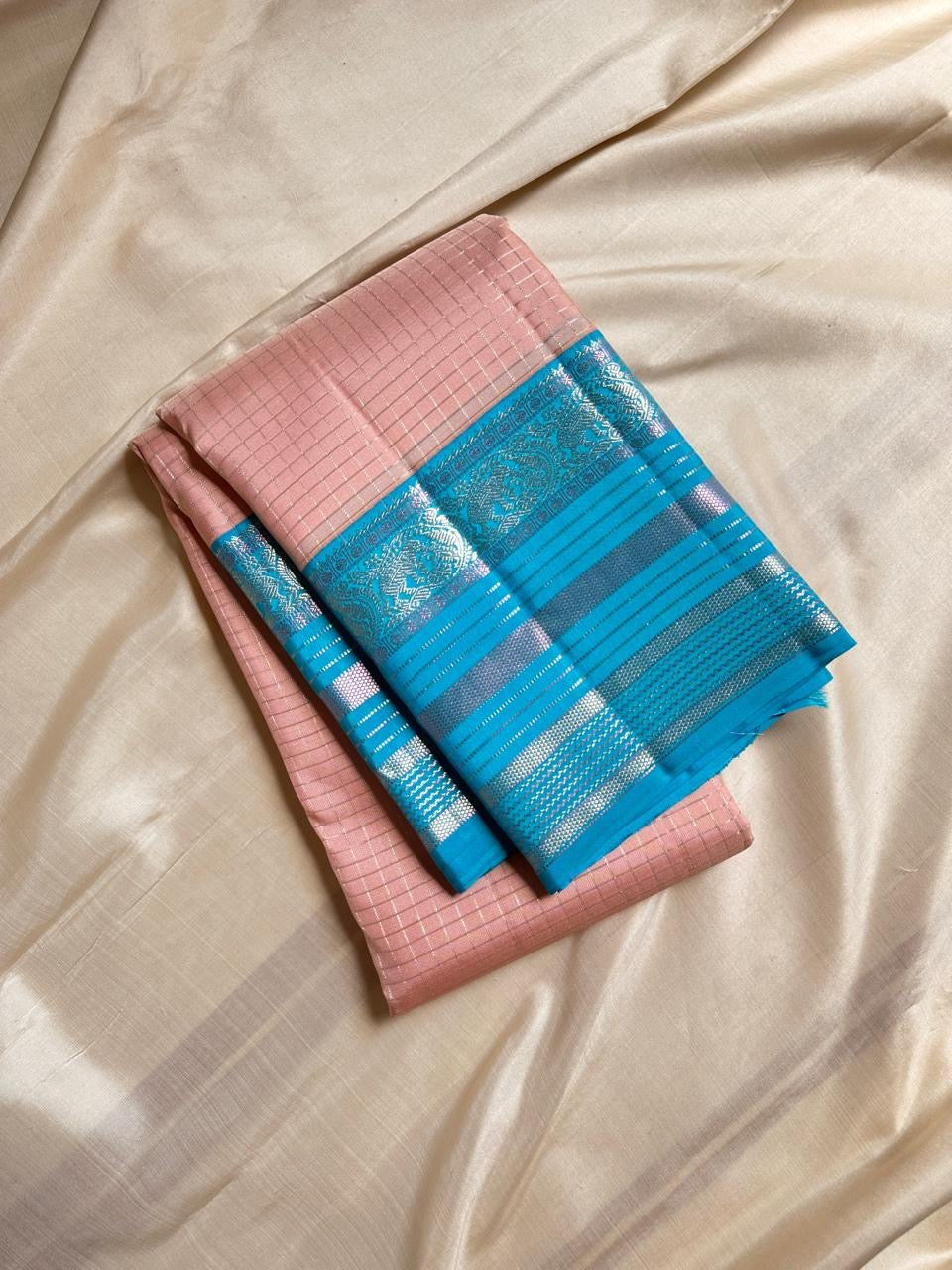Kanchipattu silk saree in blush pink with turquoise blue border Zari Kattam weave traditional zari detail