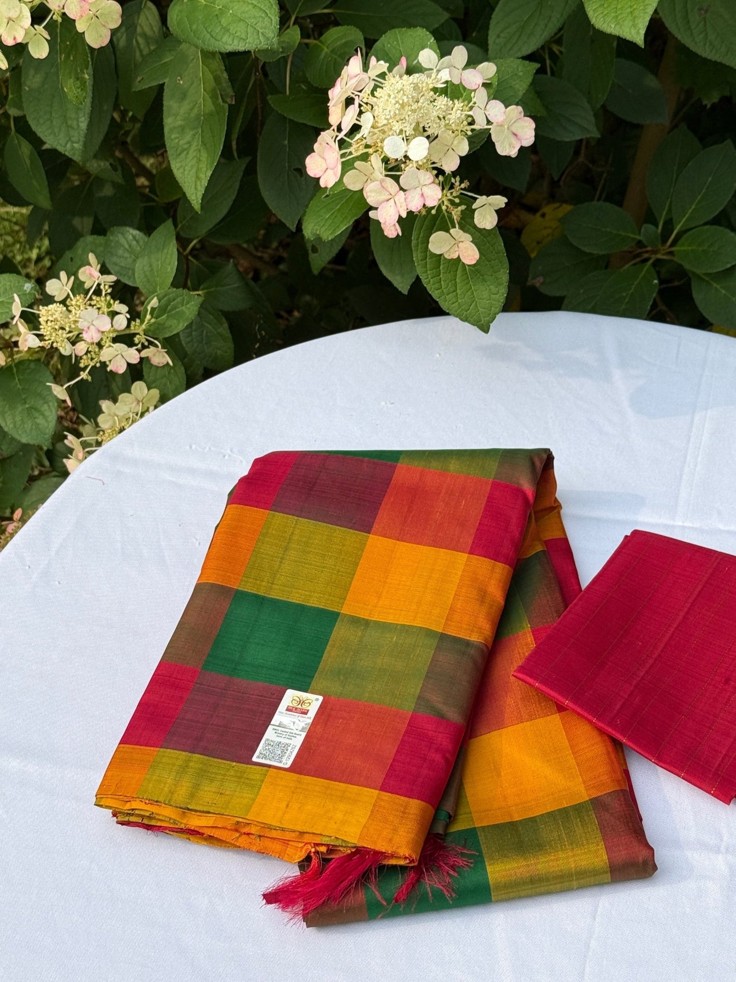 Pure Kanchipuram silk saree folded with matching plain maroon blouse piece