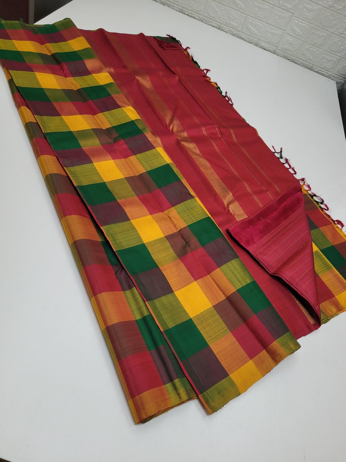 Close view of kattam check pattern in green mustard red silk weave texture