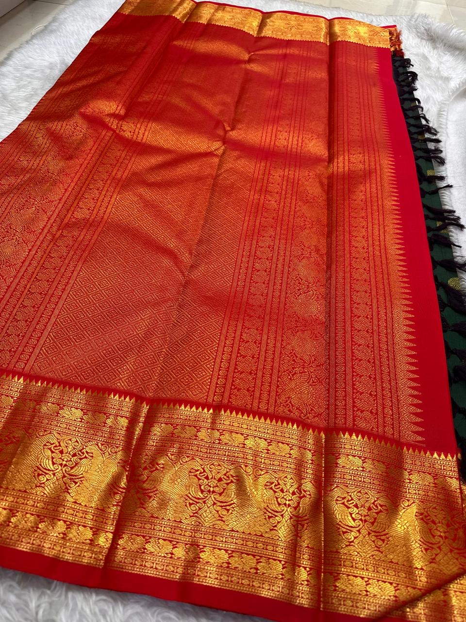 Kancheepuram handwoven butta saree in bottle green with vermilion contrast border